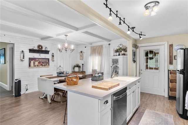 639 Plank Rd, Penfield, NY 14580 - kitchen featuring stainless steel appliances, light wood-style floors, a kitchen breakfast bar, white cabinets, and a chandelier