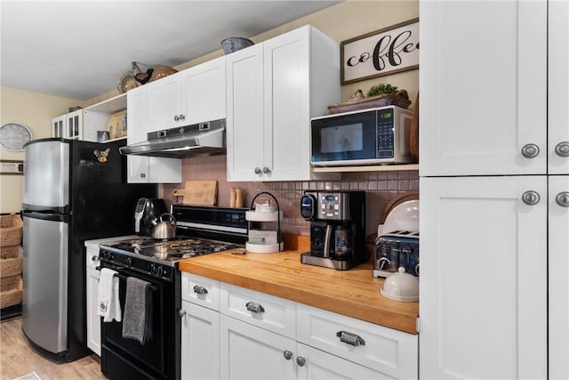 639 Plank Rd, Penfield, NY 14580 - kitchen featuring black gas stove, under cabinet range hood, wooden counters, white cabinetry, and backsplash