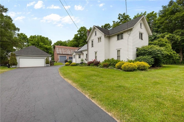 639 Plank Rd, Penfield, NY 14580 - view of front of property with a detached garage, a front lawn, and a chimney