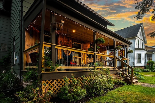 258 E State St, Albion, NY 14411 - back of property at dusk featuring a porch