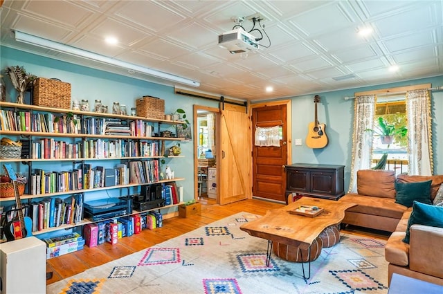 258 E State St, Albion, NY 14411 - living area with a barn door, wood finished floors, an ornate ceiling, and recessed lighting