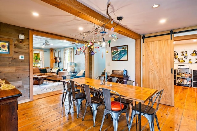 258 E State St, Albion, NY 14411 - dining room featuring recessed lighting, light wood finished floors, a barn door, beam ceiling, and wood walls