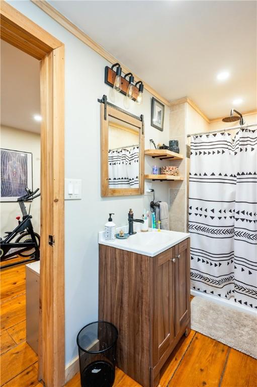 258 E State St, Albion, NY 14411 - bathroom featuring wood finished floors, ornamental molding, vanity, and a shower with curtain