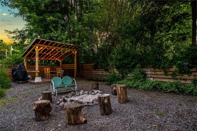 258 E State St, Albion, NY 14411 - patio terrace at dusk with a fenced backyard, a gazebo, a deck, and grilling area