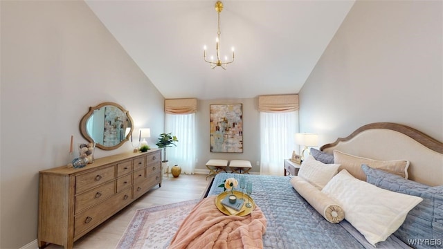 37A Stonham Pl, Amherst, NY 14221 - bedroom with lofted ceiling, a chandelier, and light wood-style floors