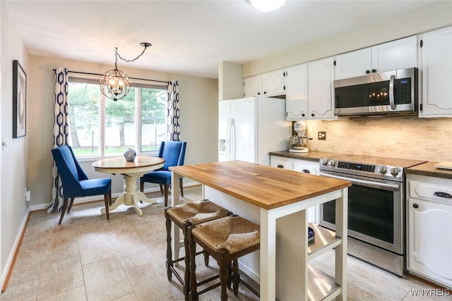92 Bridle Path, Amherst, NY 14221 - kitchen with appliances with stainless steel finishes, wood counters, and white cabinetry