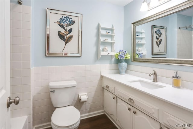 92 Bridle Path, Amherst, NY 14221 - full bath featuring tile walls, vanity, wainscoting, wood finished floors, and shower / washtub combination