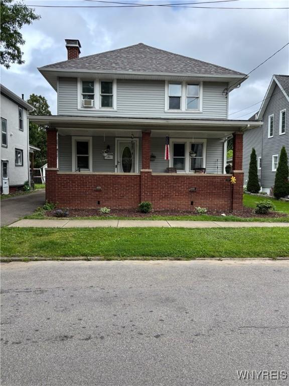 126 N 8th St, Olean-City, NY 14760 - traditional style home featuring covered porch, brick siding, and a chimney