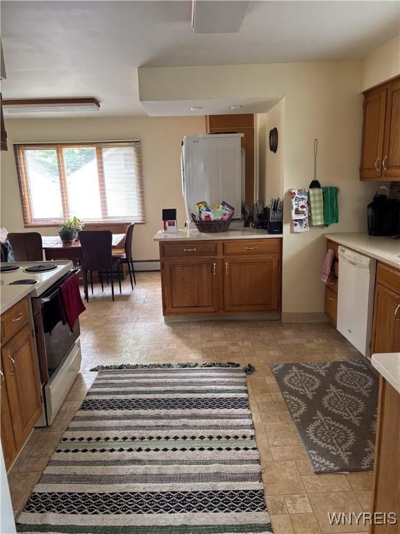 126 N 8th St, Olean-City, NY 14760 - kitchen featuring white appliances, brown cabinetry, and light countertops