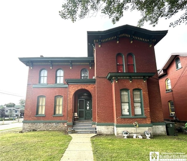 362 E 4th St, Jamestown, NY 14701 - view of front facade featuring brick siding and a front yard