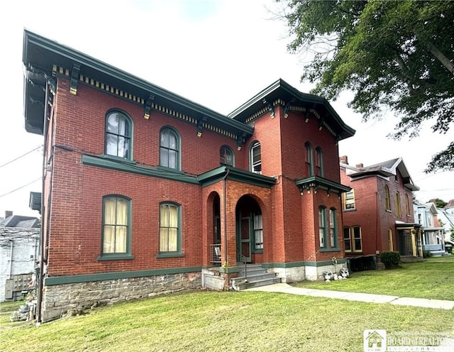 362 E 4th St, Jamestown, NY 14701 - view of front of home with brick siding and a front lawn
