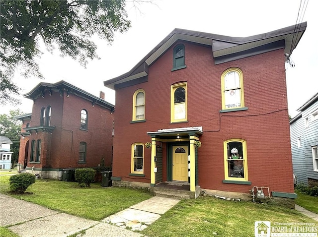362 E 4th St, Jamestown, NY 14701 - view of front facade featuring a front yard and brick siding