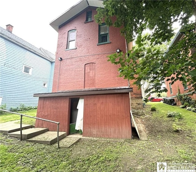 362 E 4th St, Jamestown, NY 14701 - back of property featuring a barn, an outdoor structure, and brick siding