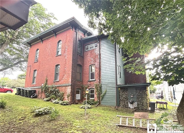 362 E 4th St, Jamestown, NY 14701 - view of property exterior featuring brick siding and a lawn