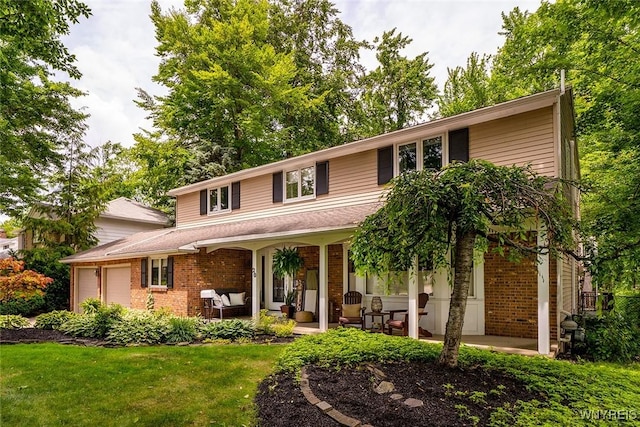 20 Dan Troy Dr, Amherst, NY 14221 - traditional-style home with an outdoor hangout area, a garage, brick siding, a front yard, and a patio
