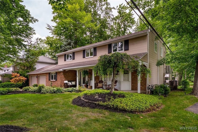20 Dan Troy Dr, Amherst, NY 14221 - traditional home featuring an attached garage, brick siding, a front lawn, and an outdoor living space