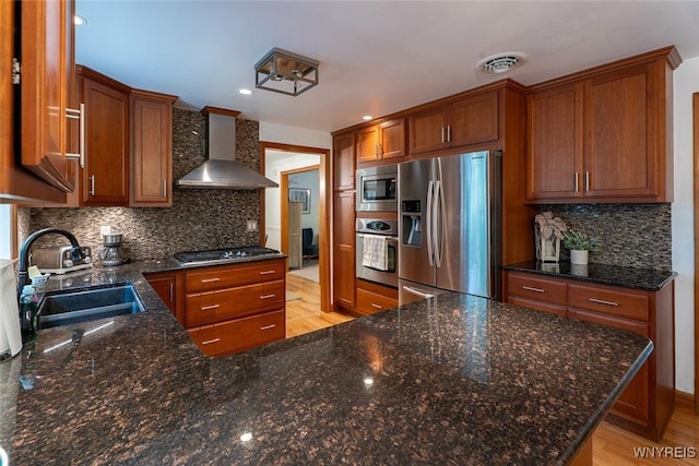 20 Dan Troy Dr, Amherst, NY 14221 - kitchen with stainless steel appliances, wall chimney exhaust hood, brown cabinetry, decorative backsplash, and recessed lighting
