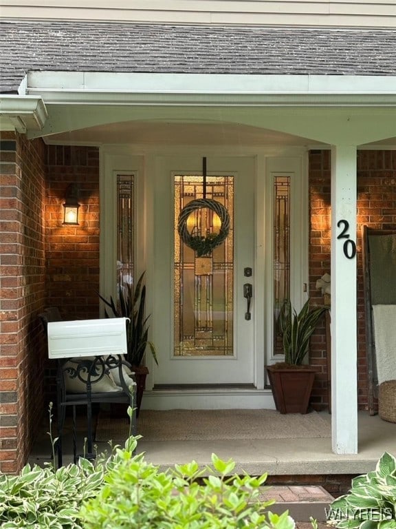20 Dan Troy Dr, Amherst, NY 14221 - property entrance featuring a porch and brick siding