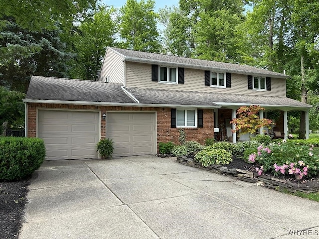 20 Dan Troy Dr, Amherst, NY 14221 - view of front of house featuring a garage, brick siding, concrete driveway, and a shingled roof