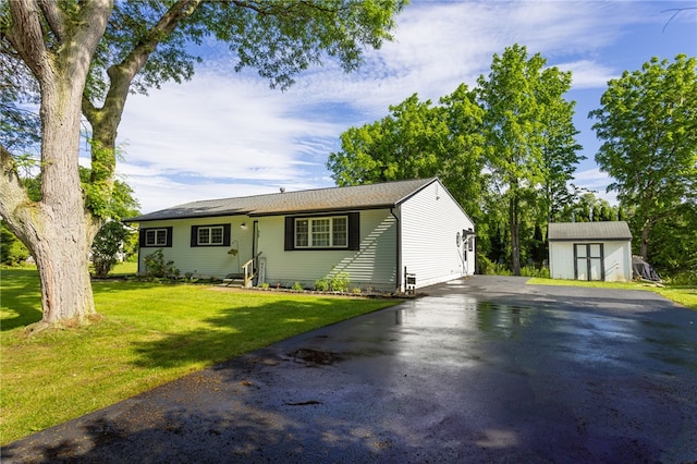 32 Princess Dr, Henrietta, NY 14623 - view of front of property featuring a storage unit, driveway, and a front yard