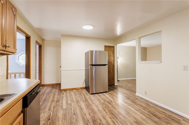 32 Princess Dr, Henrietta, NY 14623 - kitchen with stainless steel appliances, light wood-style floors, light countertops, and brown cabinets