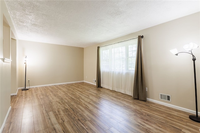32 Princess Dr, Henrietta, NY 14623 - empty room featuring wood finished floors and a textured ceiling