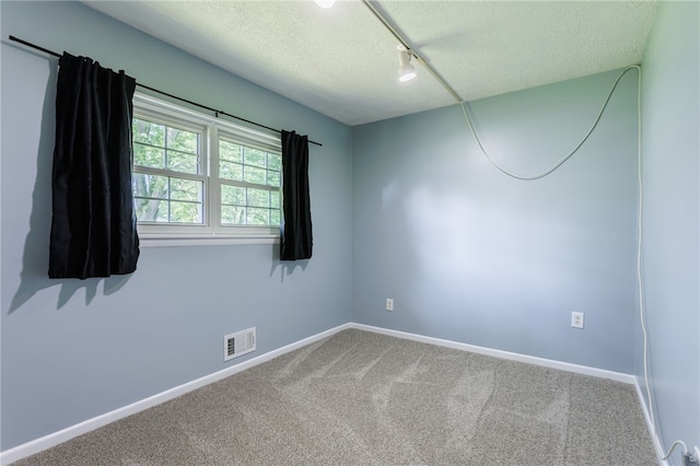 32 Princess Dr, Henrietta, NY 14623 - carpeted empty room featuring a textured ceiling and rail lighting