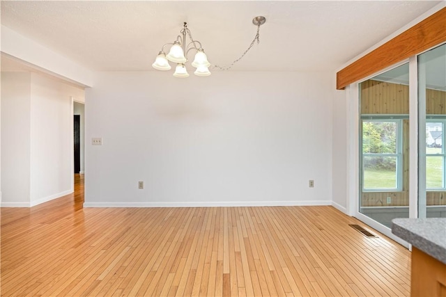 39 Southwind Ct, Greece, NY 14626 - spare room featuring a chandelier and light wood finished floors