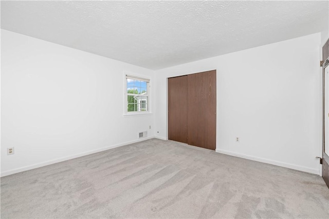 39 Southwind Ct, Greece, NY 14626 - unfurnished bedroom with light carpet, a closet, and a textured ceiling
