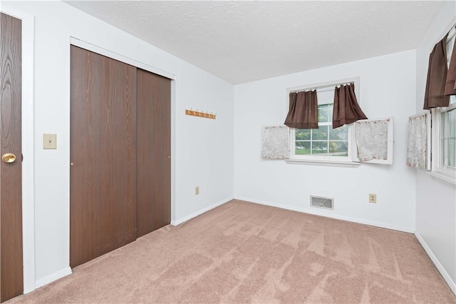 39 Southwind Ct, Greece, NY 14626 - unfurnished bedroom featuring carpet, a closet, and a textured ceiling