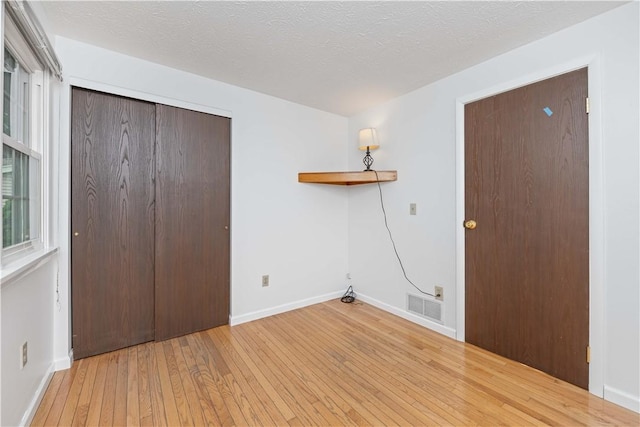 39 Southwind Ct, Greece, NY 14626 - washroom featuring wood-type flooring and a textured ceiling