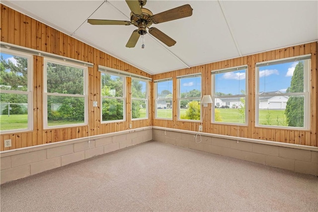 39 Southwind Ct, Greece, NY 14626 - unfurnished sunroom featuring lofted ceiling, wood walls, carpet, and concrete block wall