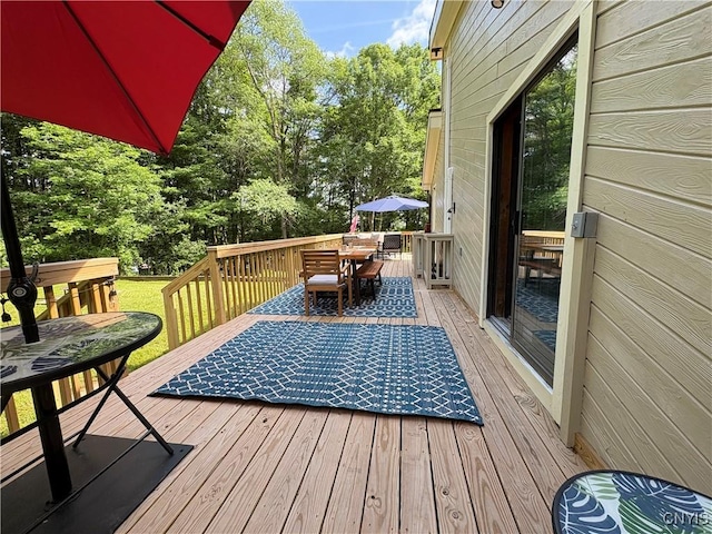 1708 Bonney Rd, Hamilton, NY 13346 - wooden terrace with outdoor dining area and view of wooded area