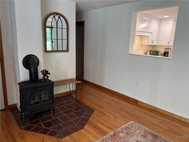 1708 Bonney Rd, Hamilton, NY 13346 - sitting room with wood finished floors and a wood stove