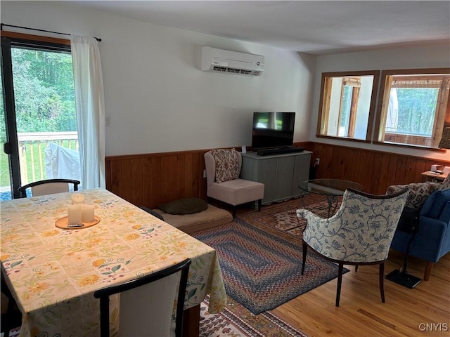 1708 Bonney Rd, Hamilton, NY 13346 - living area with a wall unit AC, wood finished floors, a wainscoted wall, and wood walls
