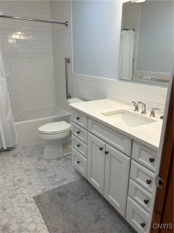 1708 Bonney Rd, Hamilton, NY 13346 - bathroom featuring vanity, shower / tub combo, and tile walls
