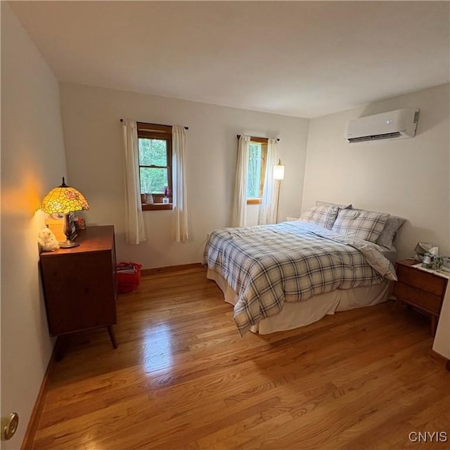 1708 Bonney Rd, Hamilton, NY 13346 - bedroom with a wall mounted air conditioner and wood finished floors