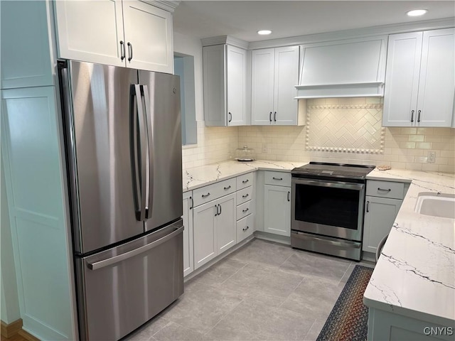 1708 Bonney Rd, Hamilton, NY 13346 - kitchen with stainless steel appliances, tasteful backsplash, light stone countertops, recessed lighting, and custom range hood
