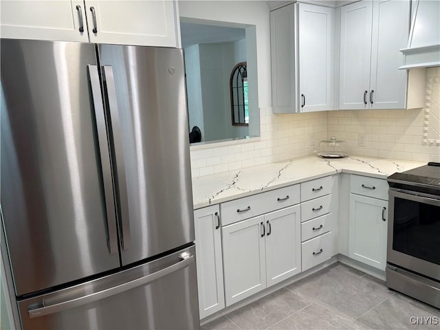 1708 Bonney Rd, Hamilton, NY 13346 - kitchen with stainless steel appliances, decorative backsplash, light stone countertops, light tile patterned floors, and white cabinetry