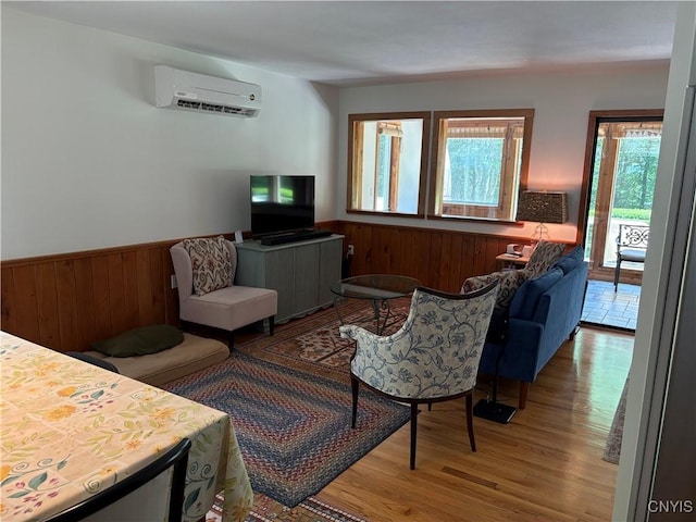1708 Bonney Rd, Hamilton, NY 13346 - living room with an AC wall unit, wood finished floors, wainscoting, and wood walls