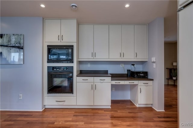 1348 Sunset Rdg, Watertown-Town, NY 13601 - kitchen with black appliances, light wood-style flooring, dark countertops, and recessed lighting