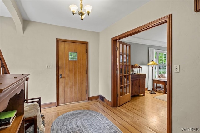 63 Chauncey Ln, Orchard Park, NY 14127 - entryway with a chandelier and light wood-style floors