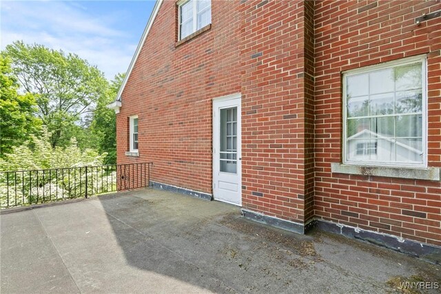 63 Chauncey Ln, Orchard Park, NY 14127 - view of property exterior featuring brick siding and a patio