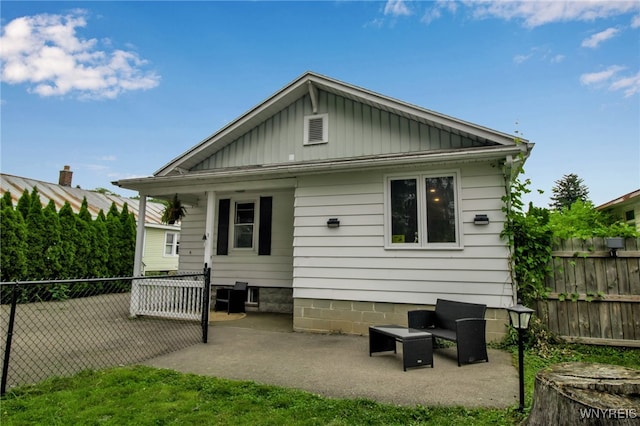 18 Bader Ave, Collins, NY 14070 - rear view of house featuring board and batten siding and a patio