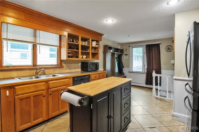 18 Bader Ave, Collins, NY 14070 - kitchen with black appliances, butcher block countertops, light tile patterned flooring, a center island, and dark cabinets