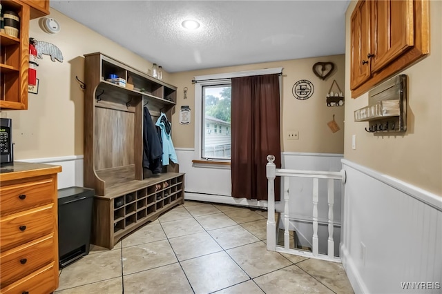 18 Bader Ave, Collins, NY 14070 - mudroom with a wainscoted wall, a textured ceiling, baseboard heating, and light tile patterned flooring