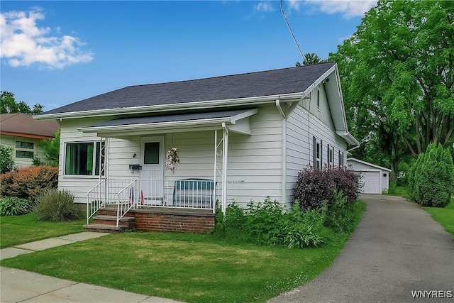 18 Bader Ave, Collins, NY 14070 - bungalow with an outbuilding, a porch, a front yard, and a detached garage