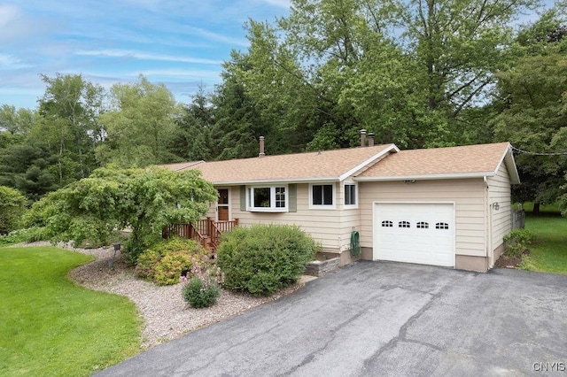 2770 Amber Rd, Marcellus, NY 13110 - single story home featuring a garage, asphalt driveway, roof with shingles, and a front yard