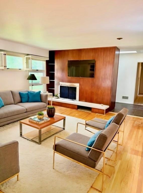 919 Fassett Rd, Elmira, NY 14905 - living area with wood finished floors and a fireplace with raised hearth