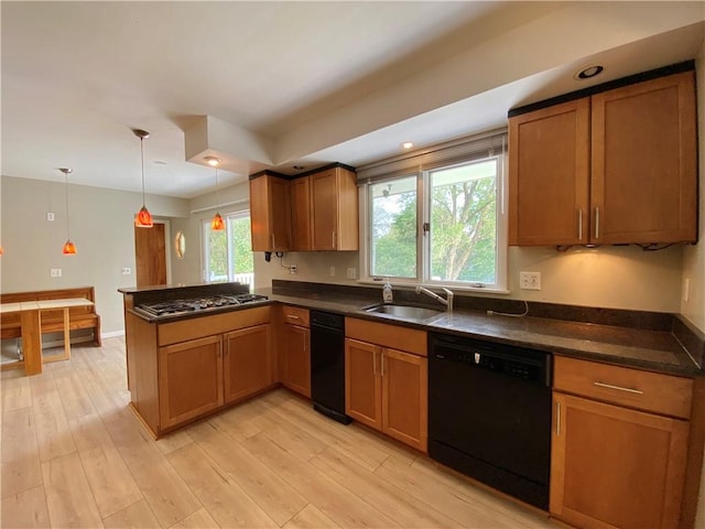 919 Fassett Rd, Elmira, NY 14905 - kitchen featuring black dishwasher, stainless steel gas stovetop, a peninsula, brown cabinetry, and recessed lighting